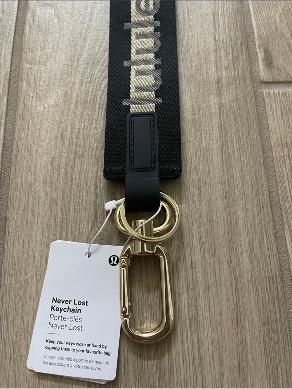 NWT Never Lost Keychain Black/ Gold Wordmark O/S